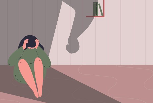 illustration of scared women sitting in corner with big shadow over her