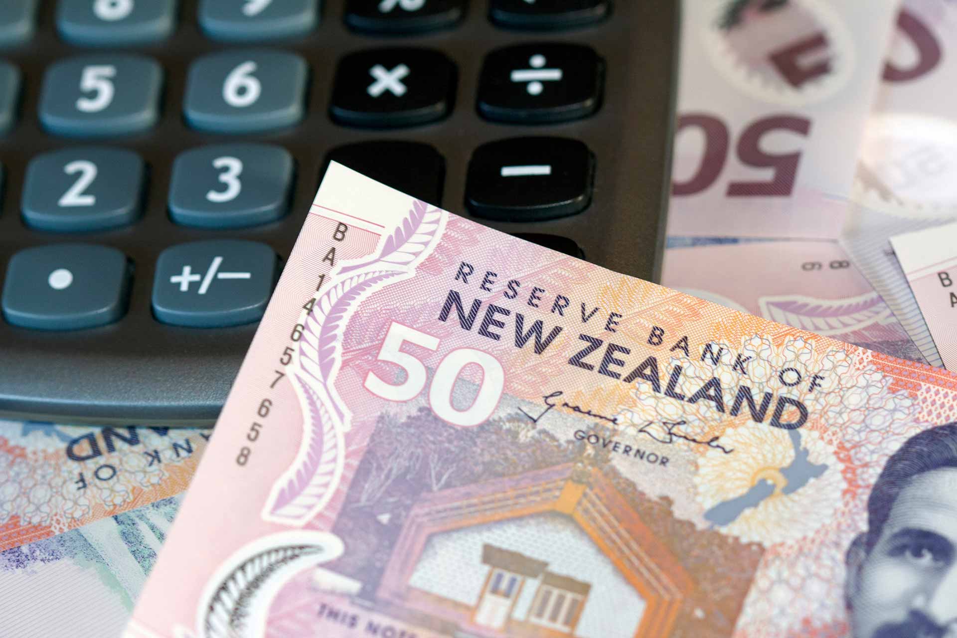 Close up of calculator and NZ $50 notes