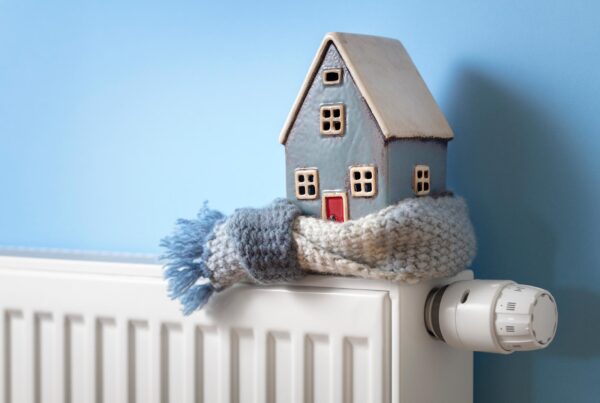 House ornament sitting on top of heater