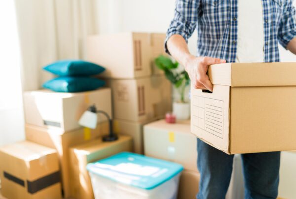 man carrying moving boxes