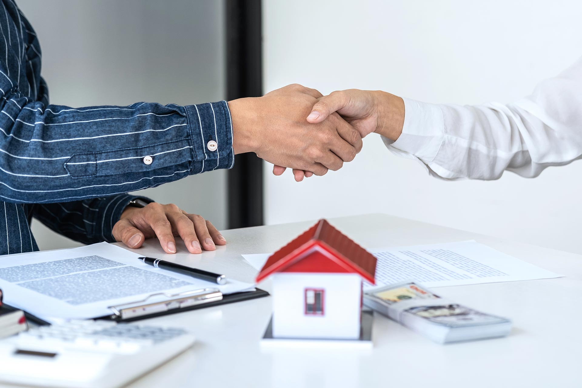 real estate agent and customers shaking hands