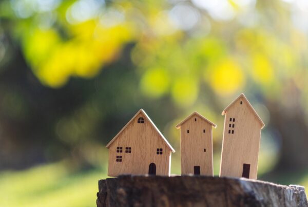 miniature wooden houses on tree stump